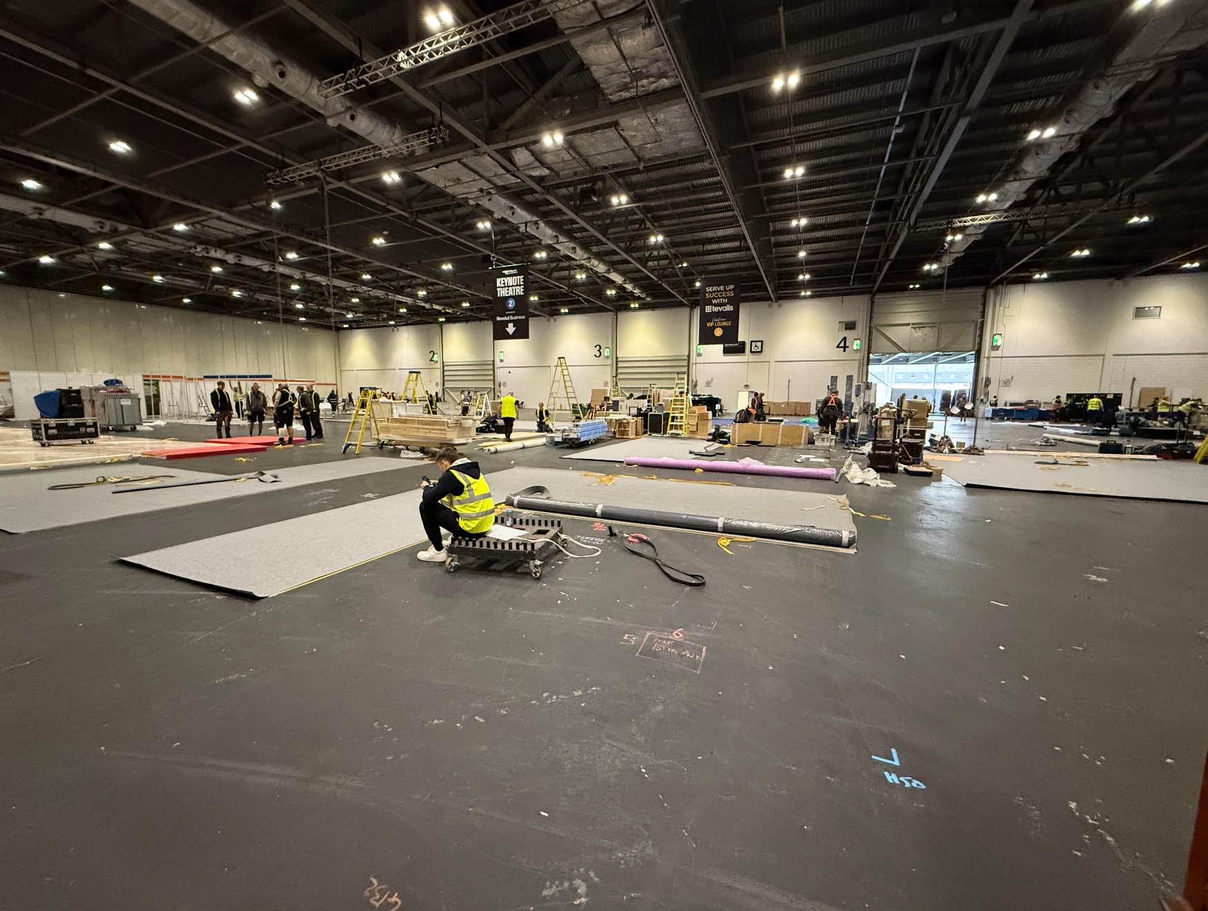Our crew laying out stand floors on build day in an exhibition hall